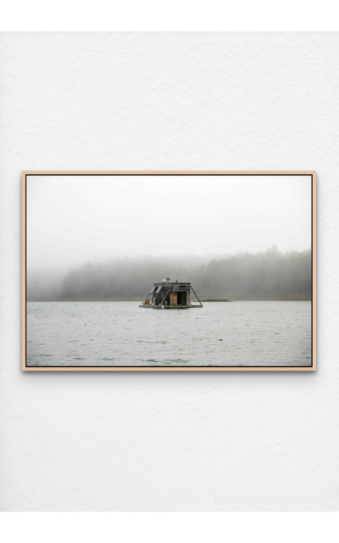 Photograph pf houseboat floating on a foggy Maine lake.