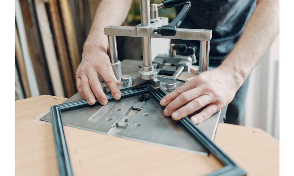 Image of man joining picture frames.