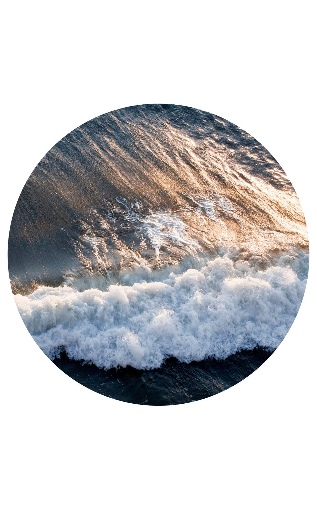 Aerial view close-up of wave crashing at sunset.