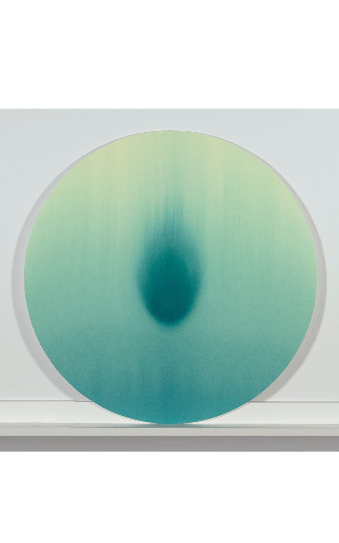 Minimal tondo watercolor with intense teal central shape with comet like quality.
