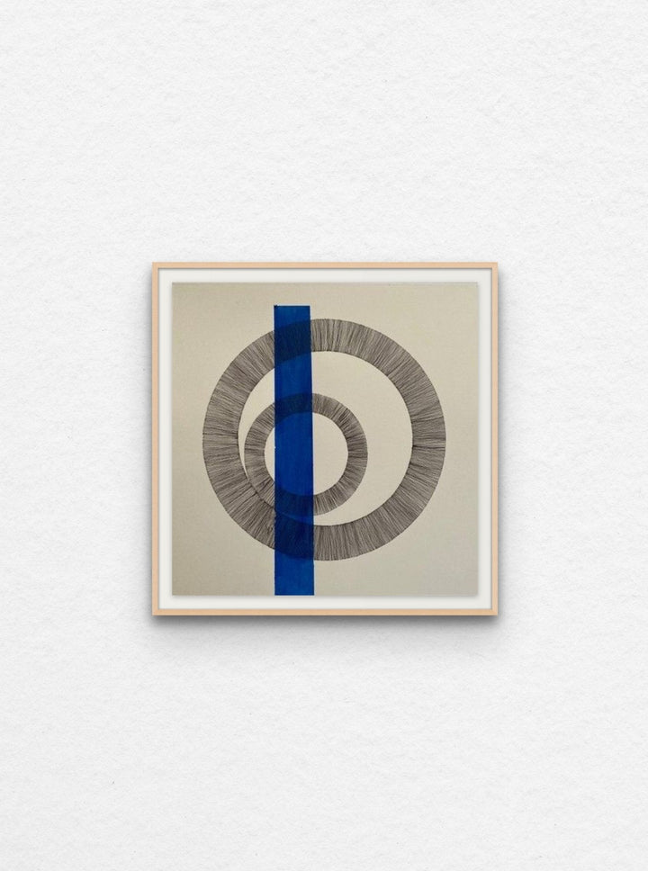 Ink drawing of two circles on paper with blue acrylic shape floated in maple frame.