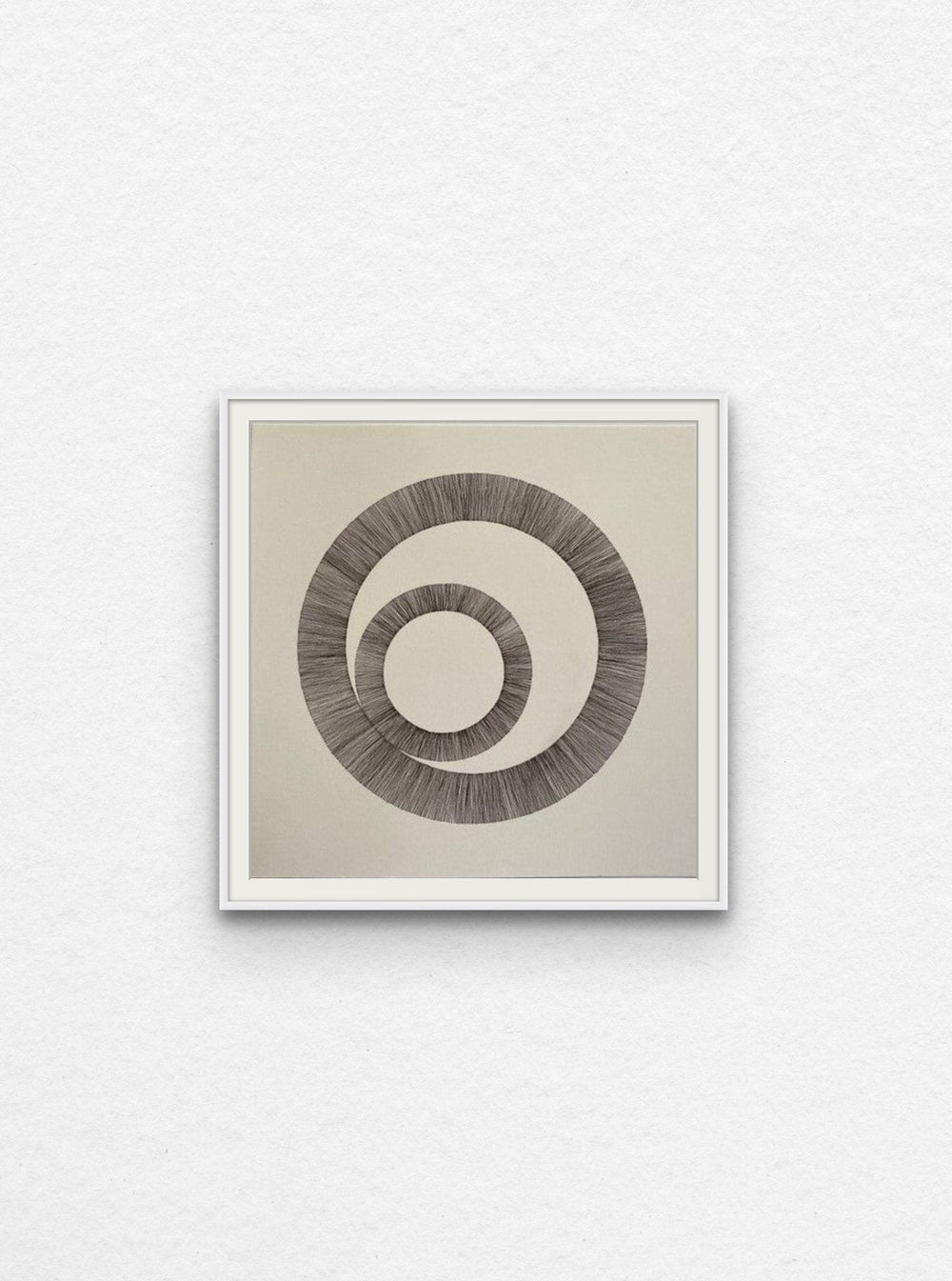 Ink drawing using lines to create two interlinked circles floated in white frame,