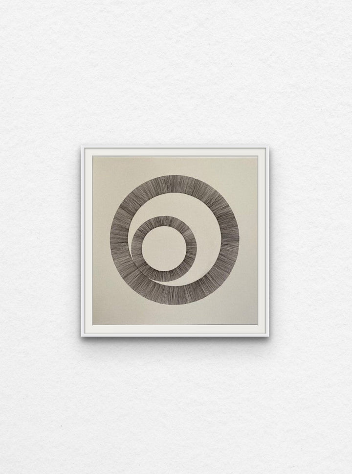 Ink drawing using lines to create two interlinked circles floated in white frame,