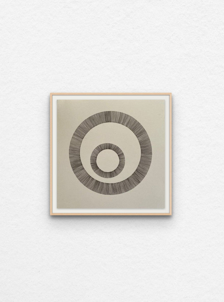 Ink art on paper of two circles floated in maple frame.