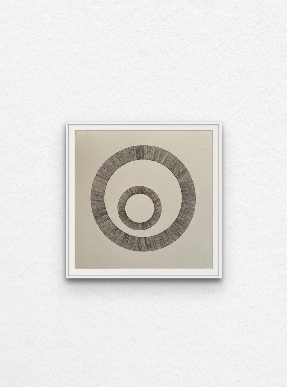 Ink drawing of two circles on paper floated in white frame.