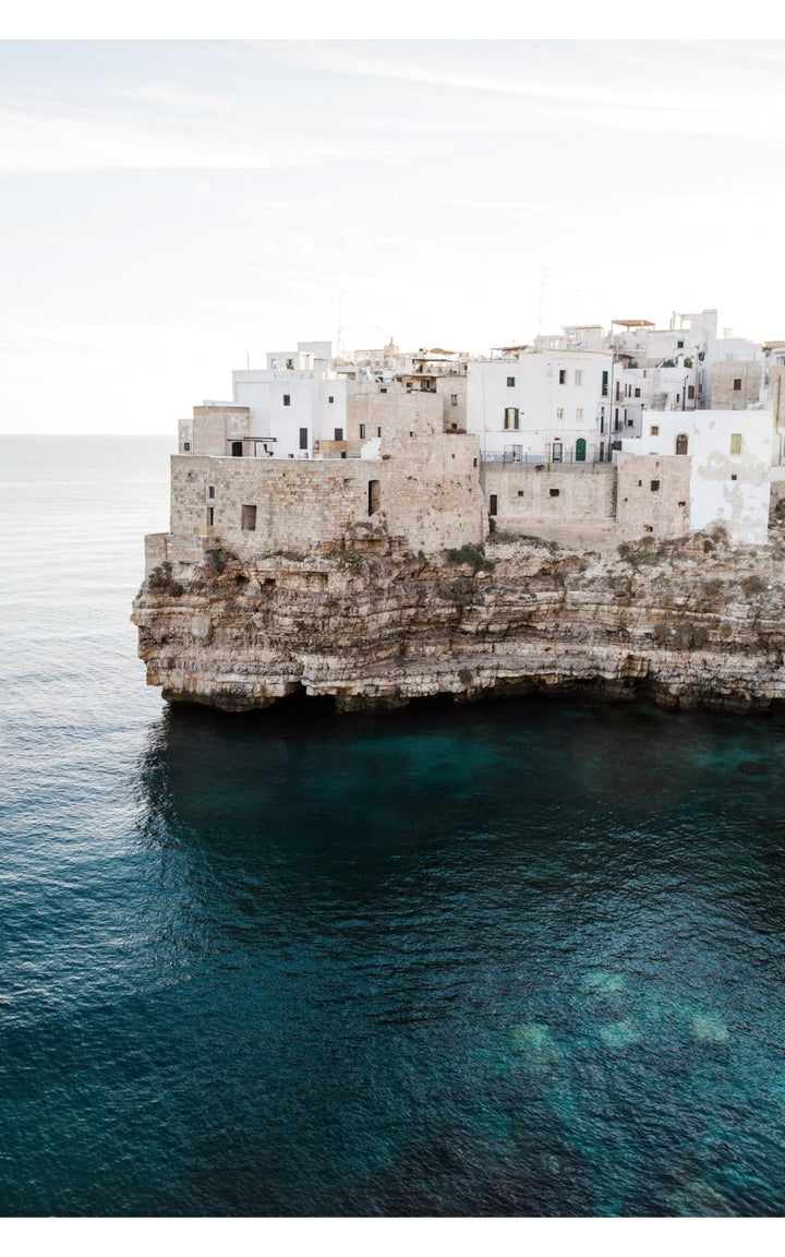 Cliffside architecture and tranquil aquamarine waters.