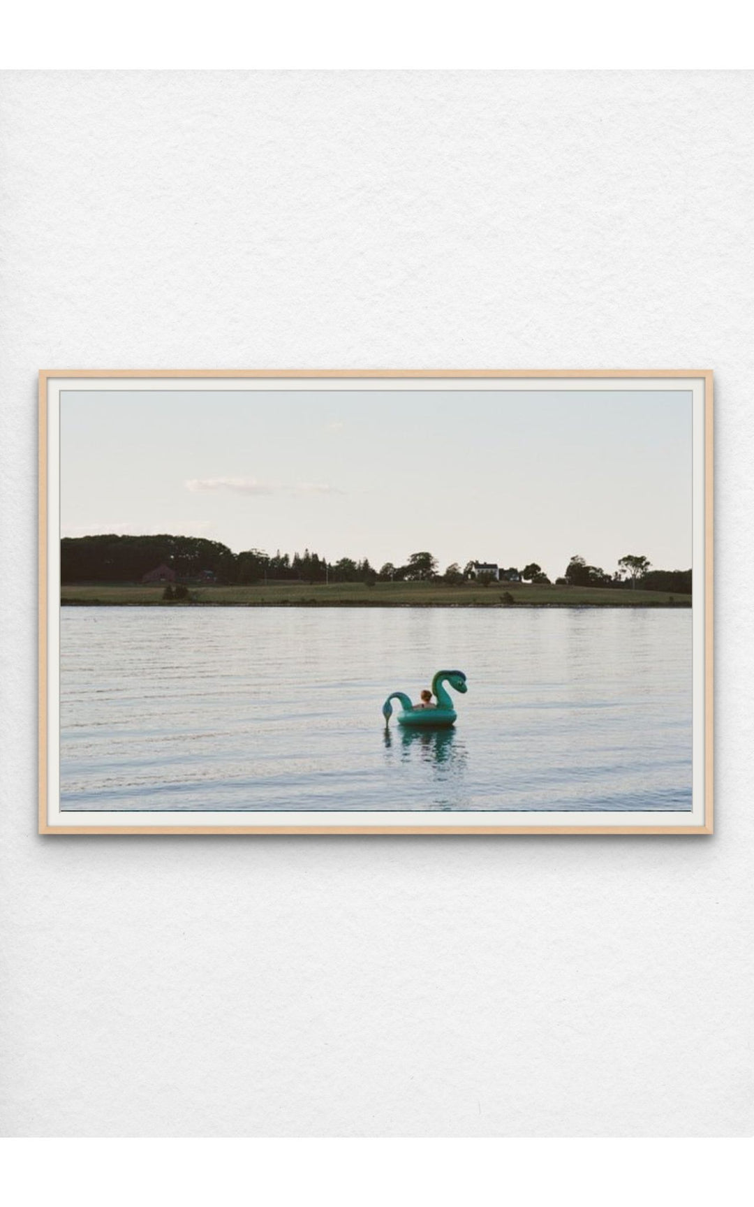 Woman on an inflatable float in the serene waters of Maine.