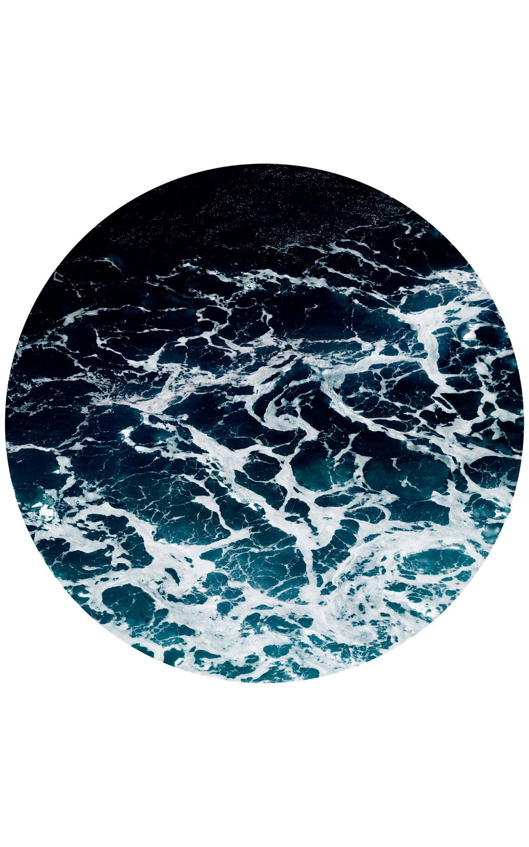 Circular photograph of whitecapped gentle waves marbling throughout the frame.