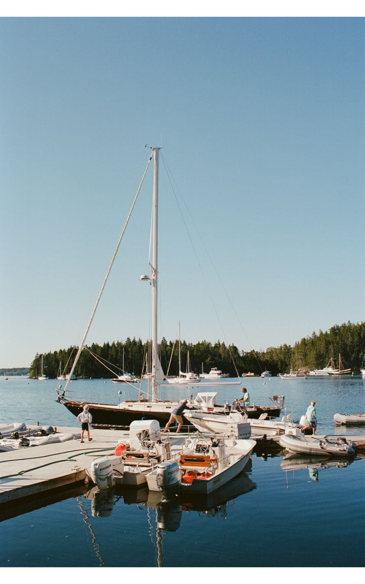 Harbor with sailboats and reflections.