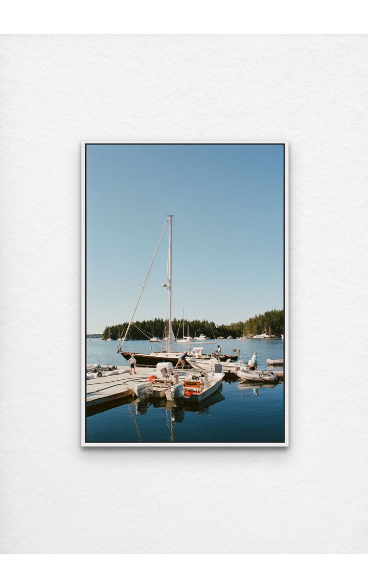 Harbor with sailboats and reflections.