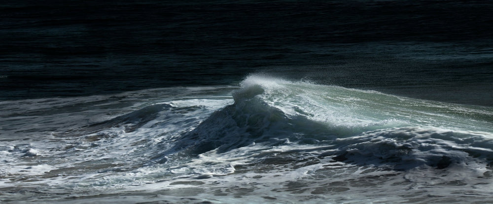 Moonlight reflecting on wave seascape.