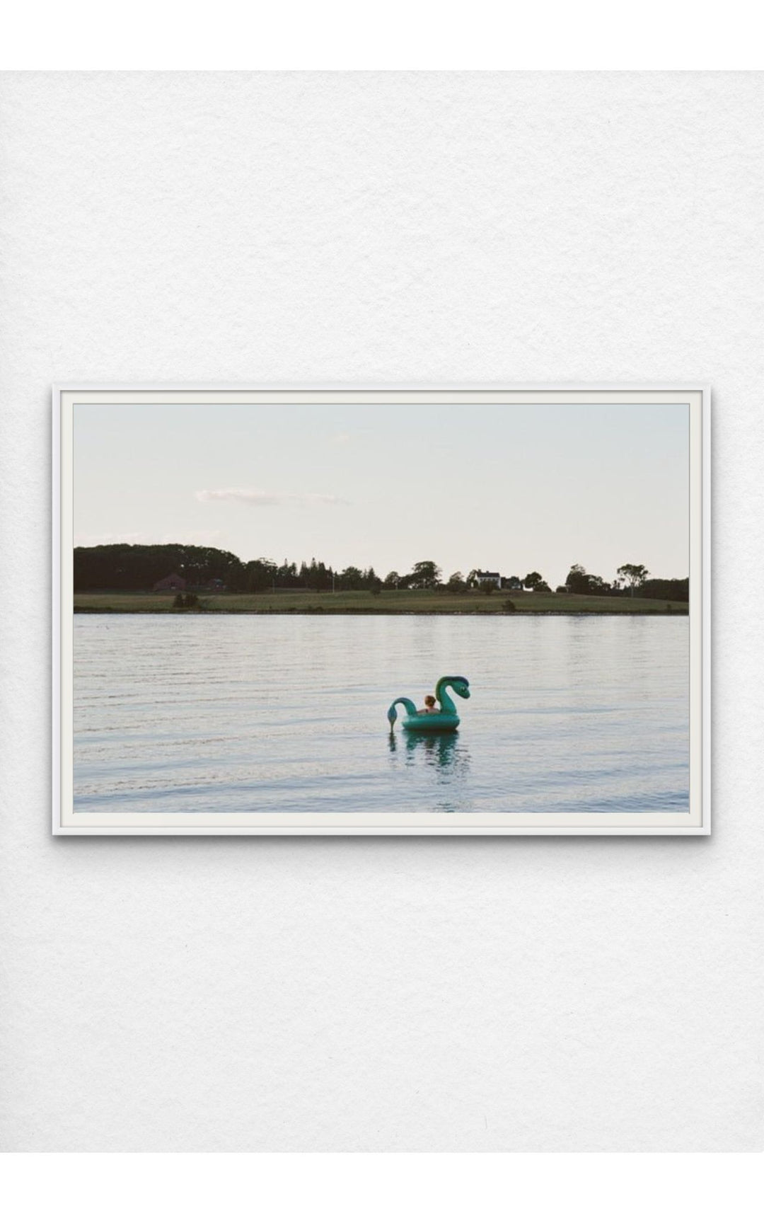 Woman on an inflatable float in the serene waters of Maine.