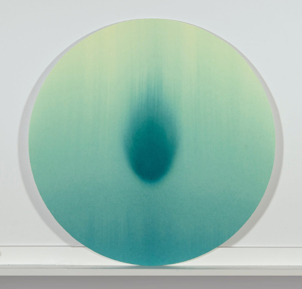 Minimal tondo watercolor with intense teal central shape with comet like quality.