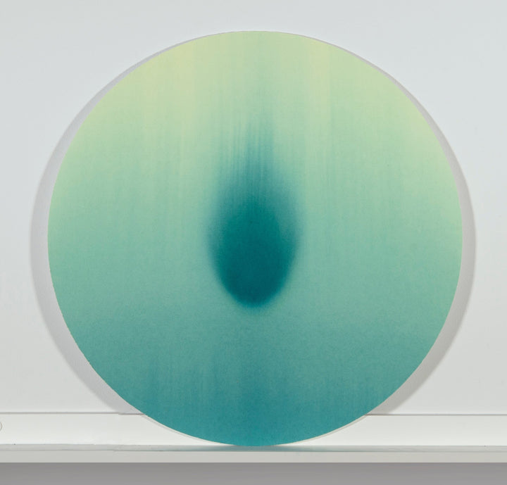Minimal tondo watercolor with intense teal central shape with comet like quality.