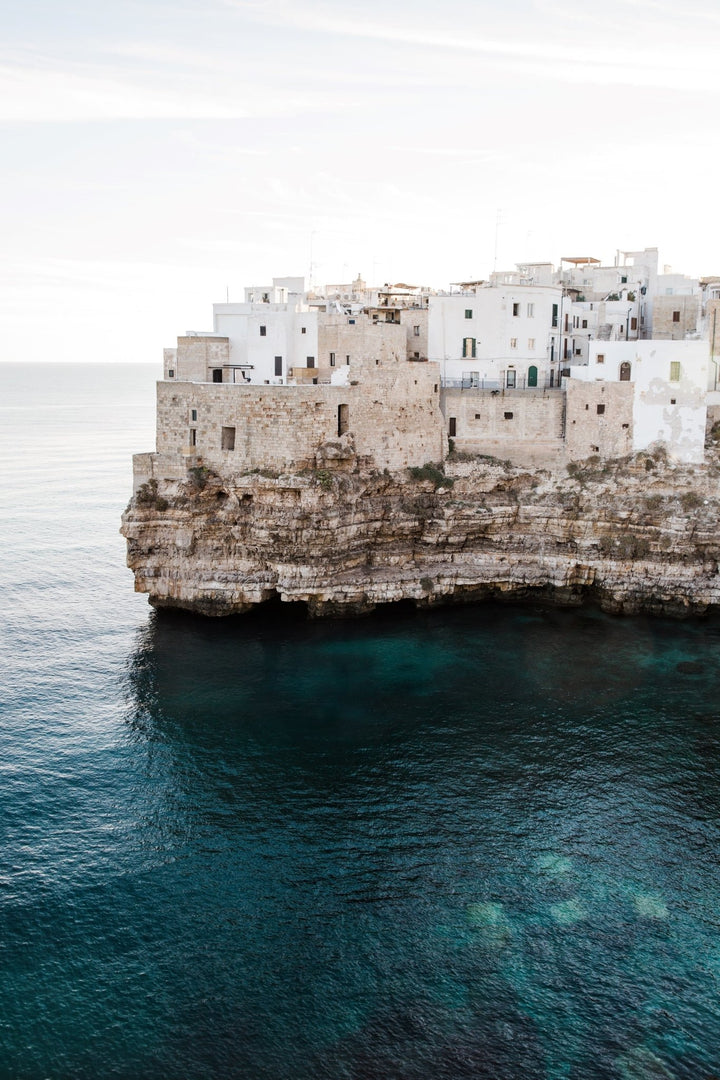 Cliffside architecture and tranquil aquamarine waters.