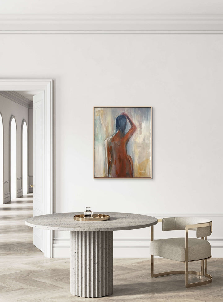 Acrylic painting of darker female figure from behind with hand on head against a light background Solace installed in modern home - Artly International