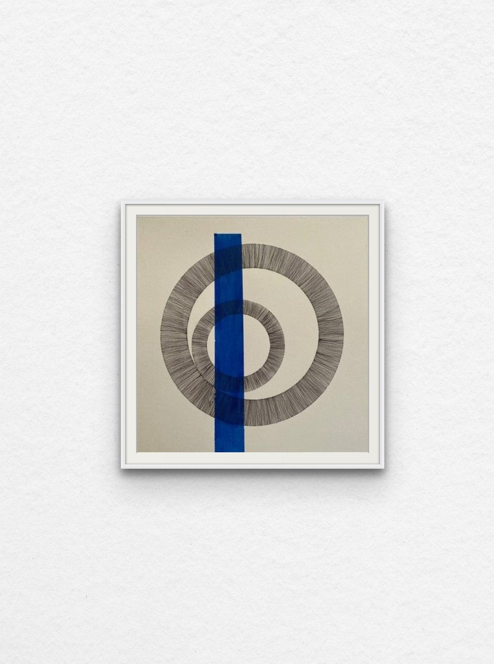 Ink drawing of two circles with blue acrylic shape floated in white frame. 