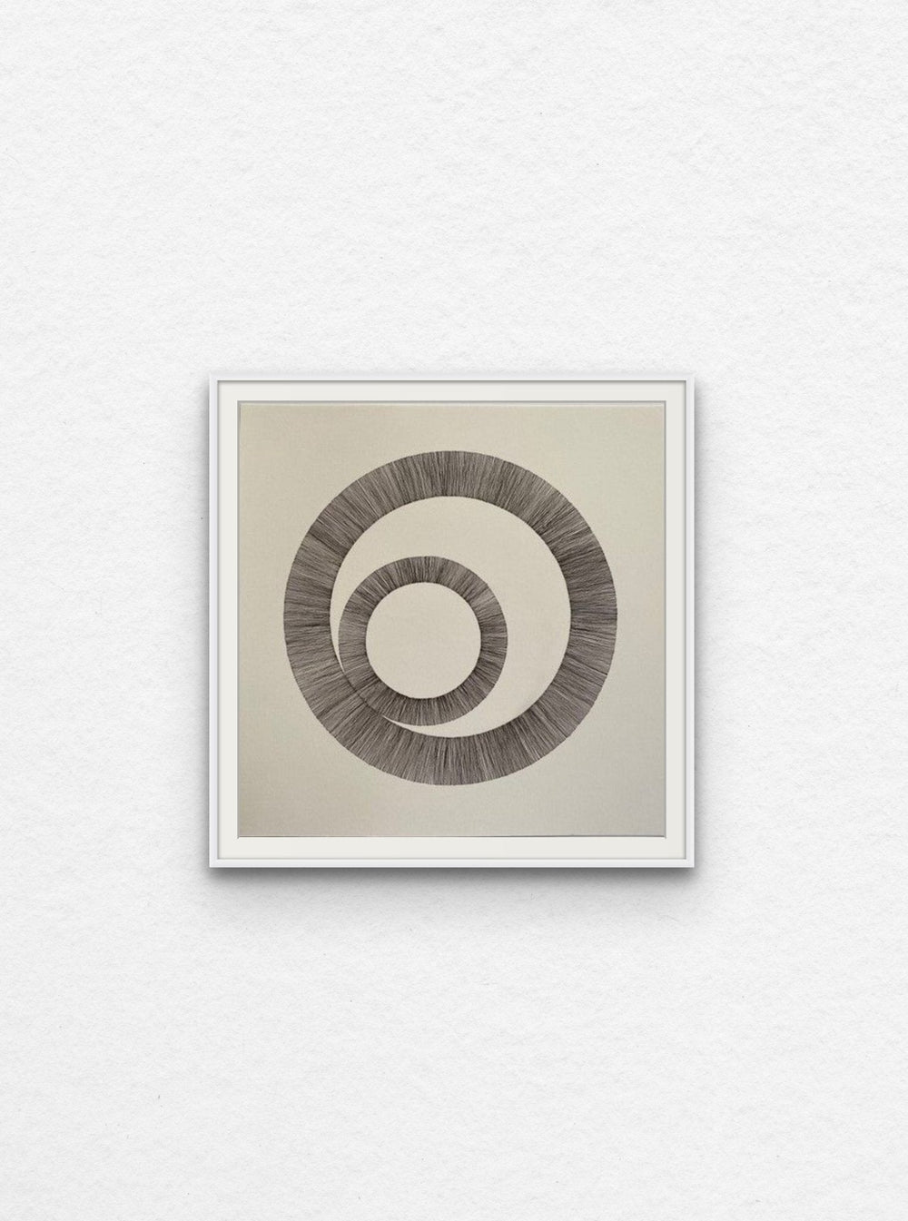 Ink drawing using lines to create two interlinked circles floated in white frame,