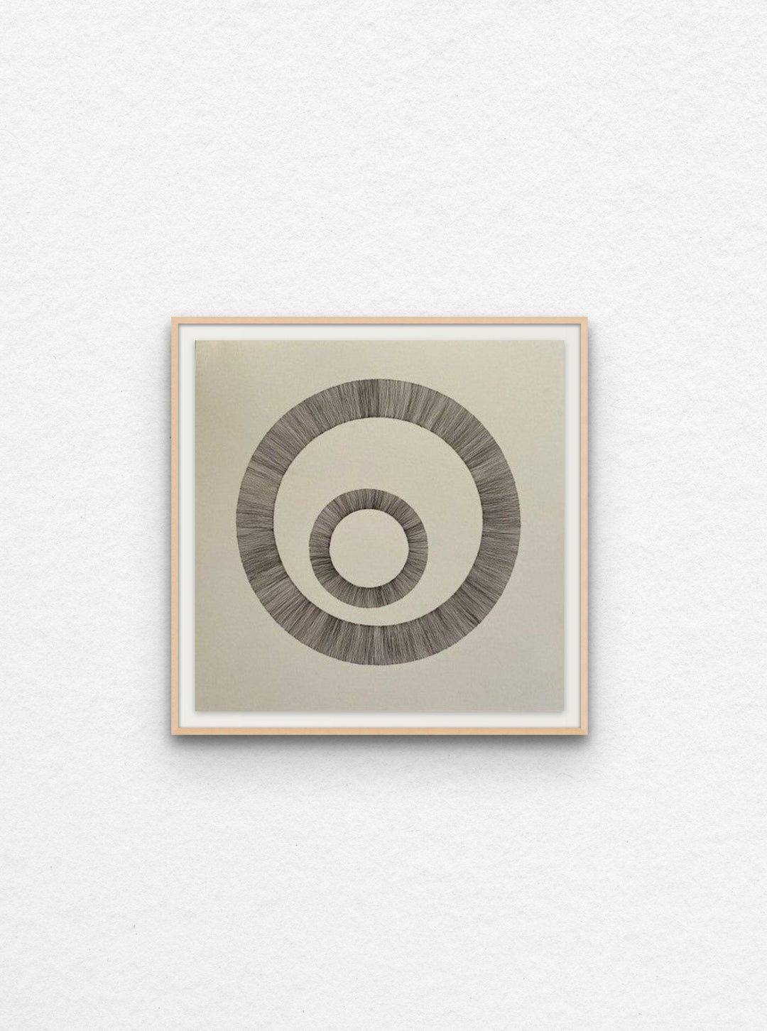 Ink art on paper of two circles floated in maple frame. 