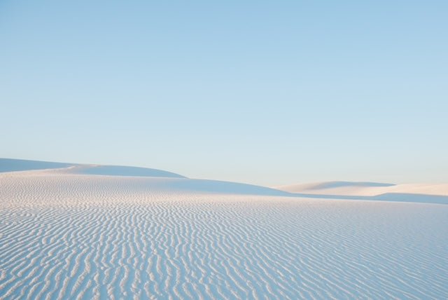 Soft ripples in the pristine dunes of White Sands, NM under a pastel sky.